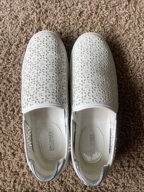 Michael Kors White Laser-Cut Floral Slip-On Sneakers with Silver Heel Tab